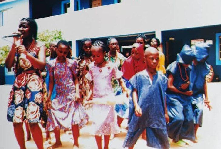 Pupils in traditional dress singing and dancing on Cultural Day