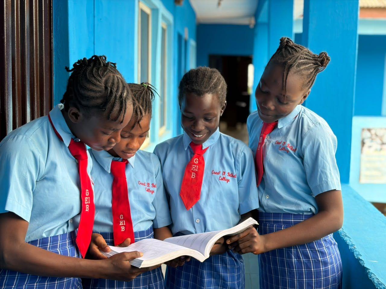 Students reading a textbook together