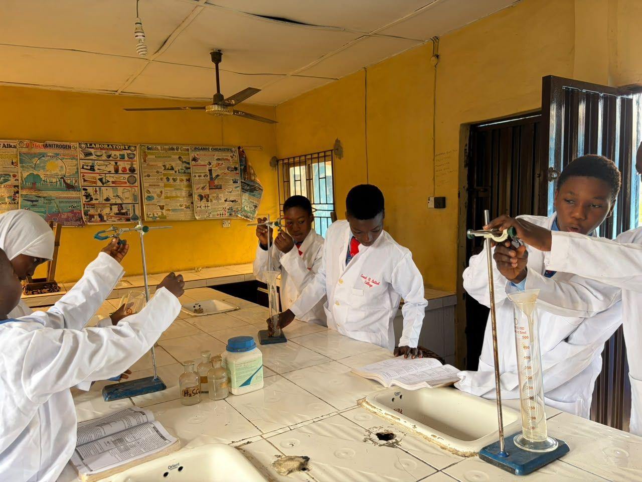 Students in lab coats working in the science laboratory
